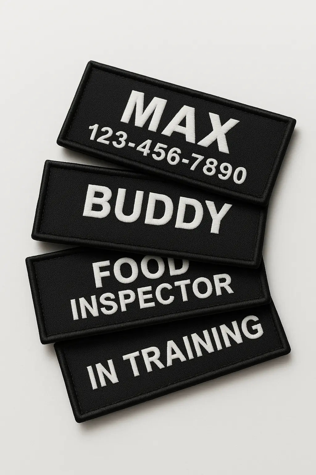Four black rectangular patches with white text on a light gray background